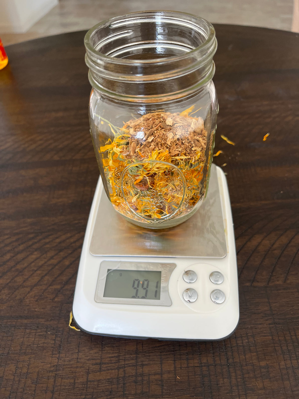 Calendula and dried botanicals measured by weight for a Vucindi herbal infusion