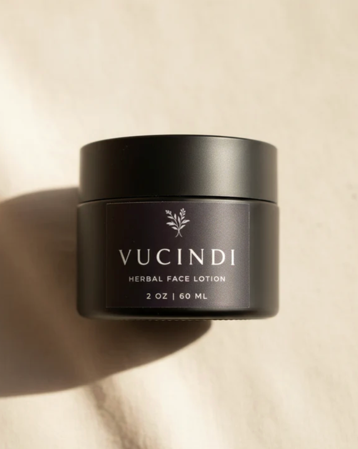 Vucindi herbal face lotion jar in warm natural light