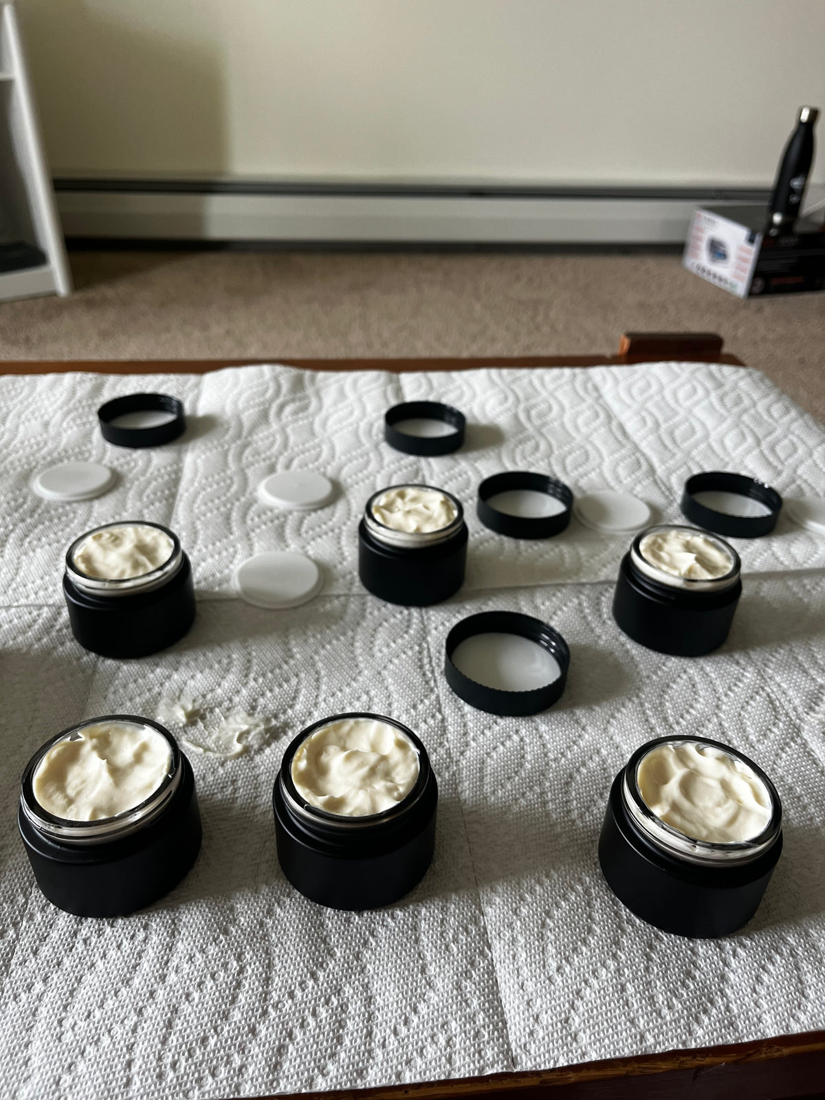 Freshly filled jars of Vucindi herbal face lotion made in a small batch